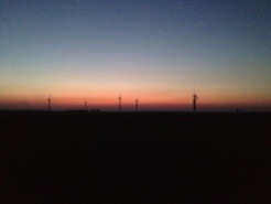 Sun setting over windturbines.